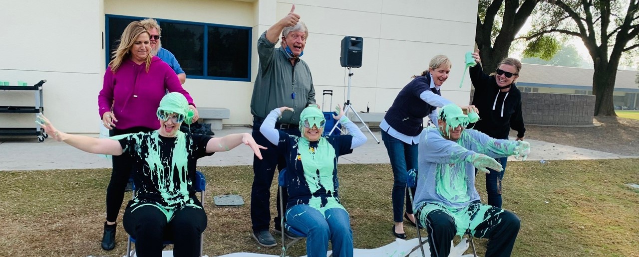 An image of FW teachers pouring slime on Mrs. Hashimoto, Mrs. Nijskens, and Mr. Le Fore.