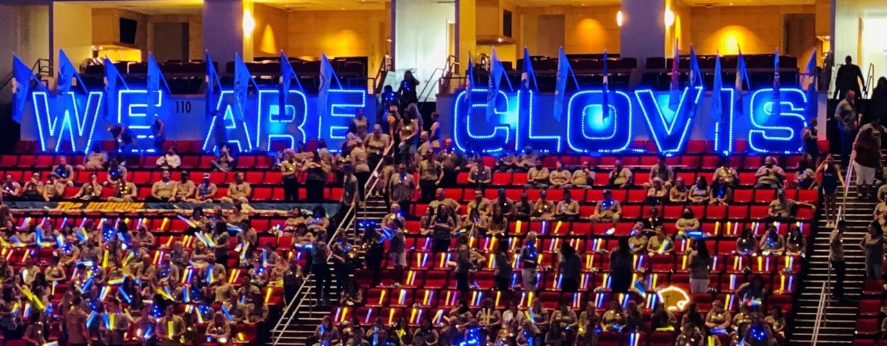 Image of a lighted neon sign that says WE ARE CLOVIS at CUSD&#39;s 2022-23 General Session.